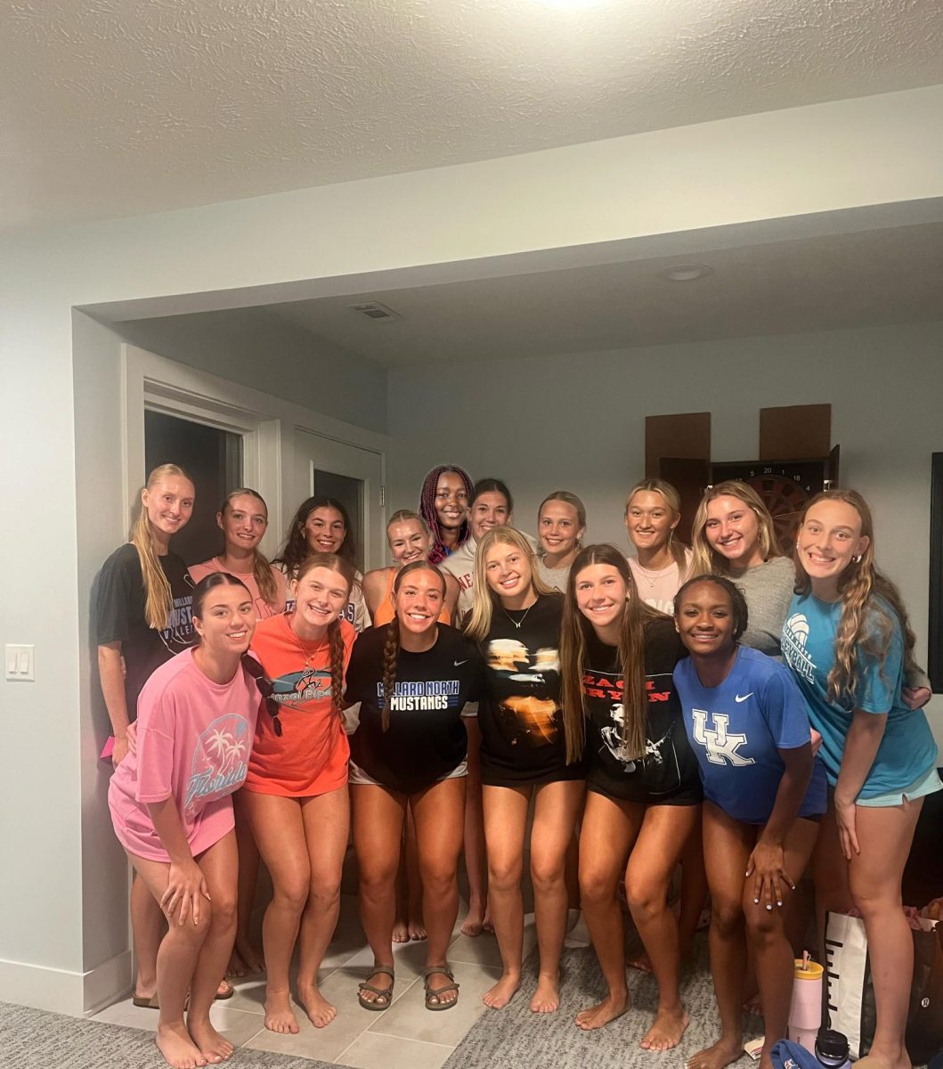 The volleyball players share a moment together. Friends both on and off the court, the team comes together to unwind and bond after intense matches.