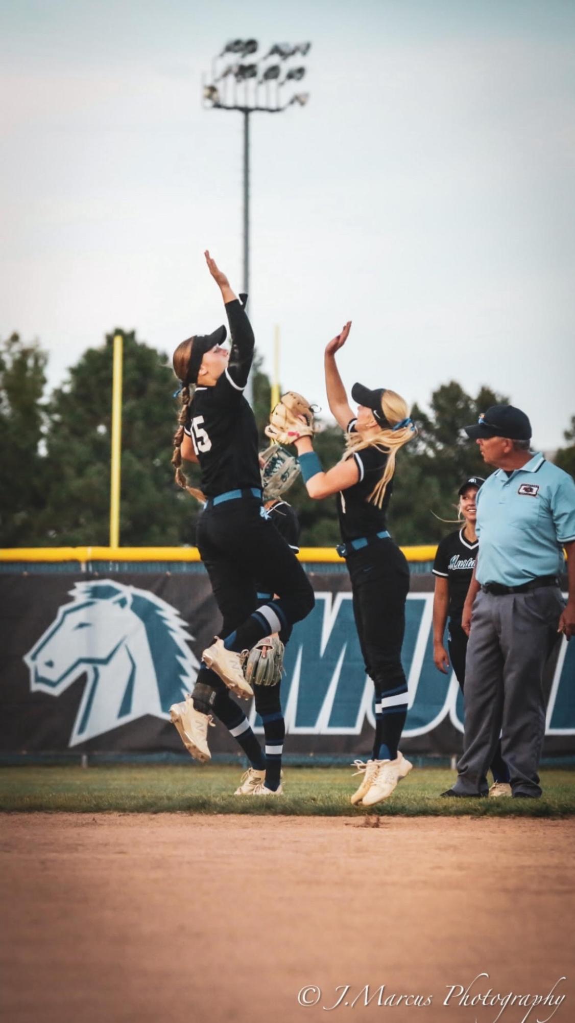 Junior Macey Jarose and senior Carley Stych celebrate with a high-five. Jarose and Stych both contributed to one of the most successful seasons in the school's history.