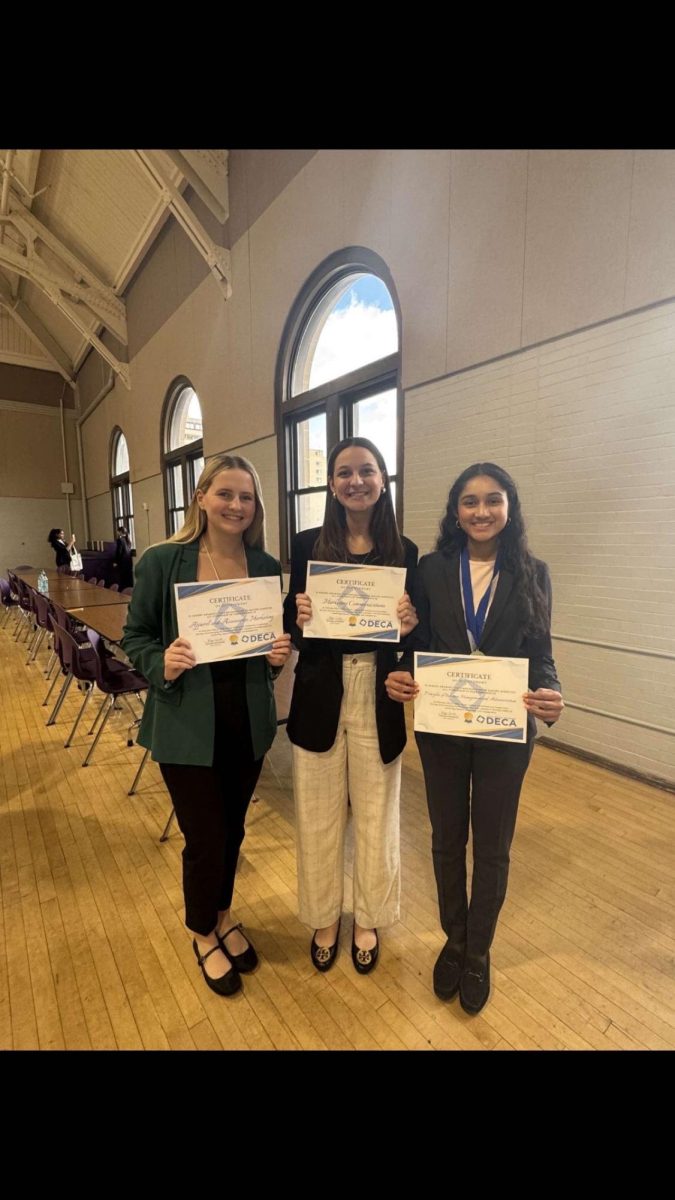 Sophomore Grace Altman, Senior Josie DeNourie, and Junior Meruni Are hold their Top 8 certificates at the Omaha Central DECA Invite on Nov.9. It was these new members' first competition. As DECA's first competition of the year, the Central Invite was especially exciting for new DECA members. 