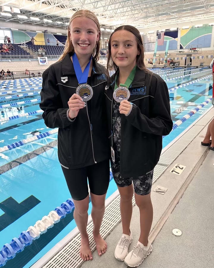 Inman and freshman Alice Ogura receive their medals at Zones in North Dakota. Inman got first for the 100 meter freestyle.